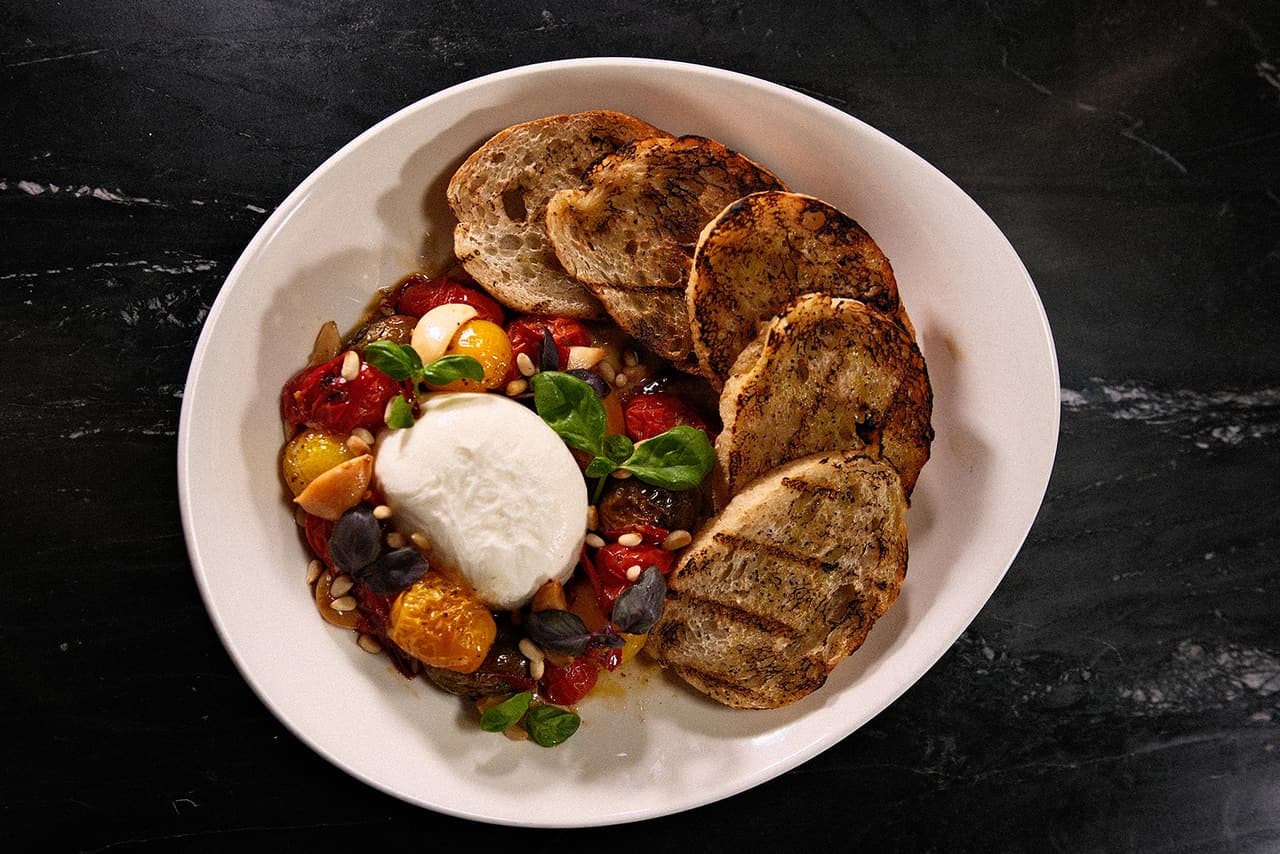 Shareable starter with grilled bread and tomatoes