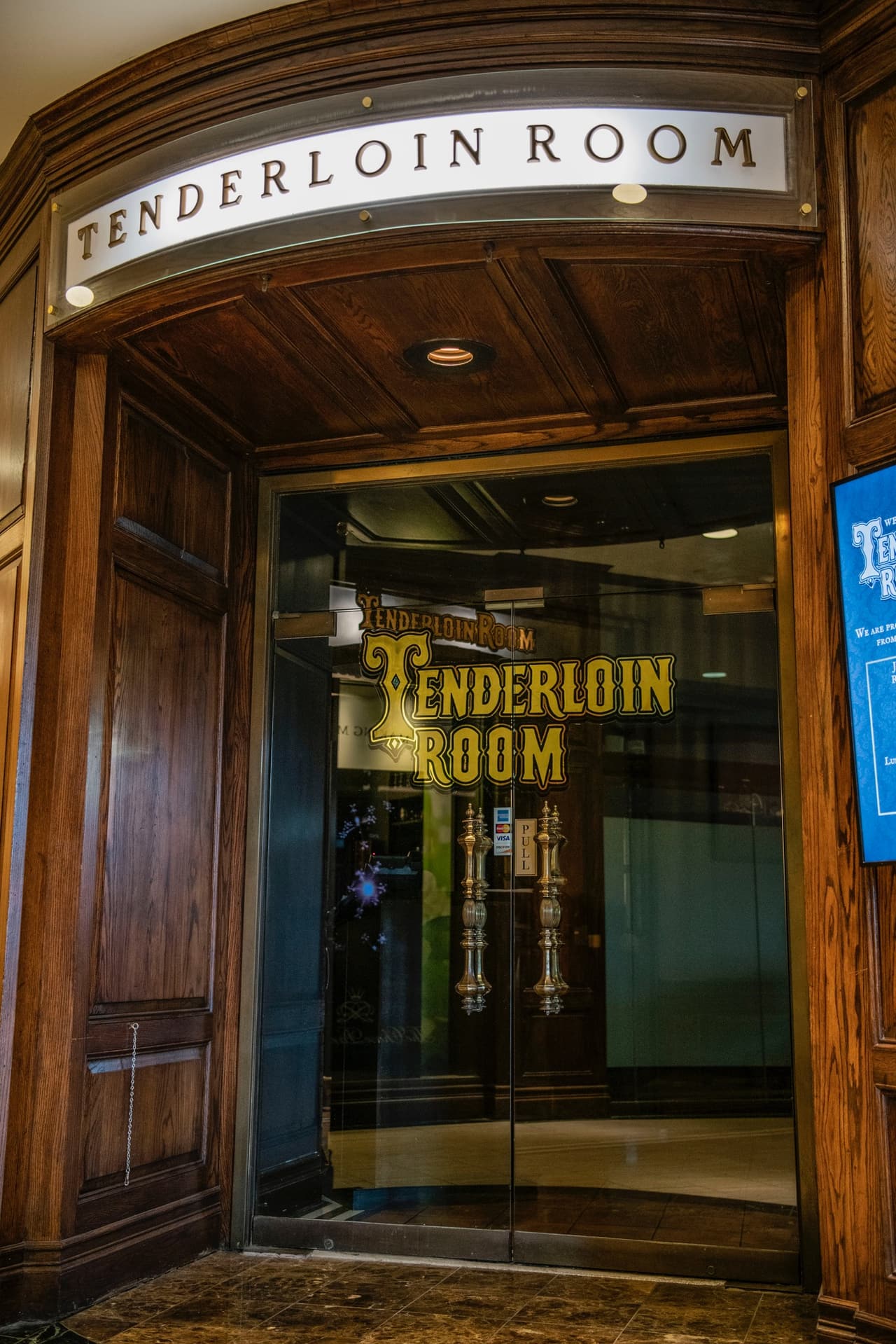 The Tenderloin Room’s front doors, with the gold lettered glass, inside the Chase Park Plaza